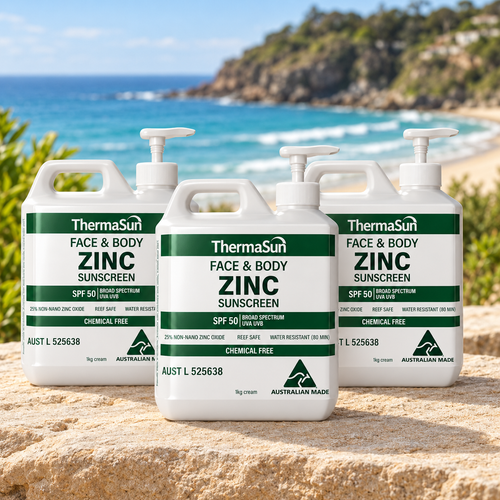 Three 1kg pumps of ThermaSun Face & Body Zinc Sunscreen SPF50 on a rock at an Australian beach